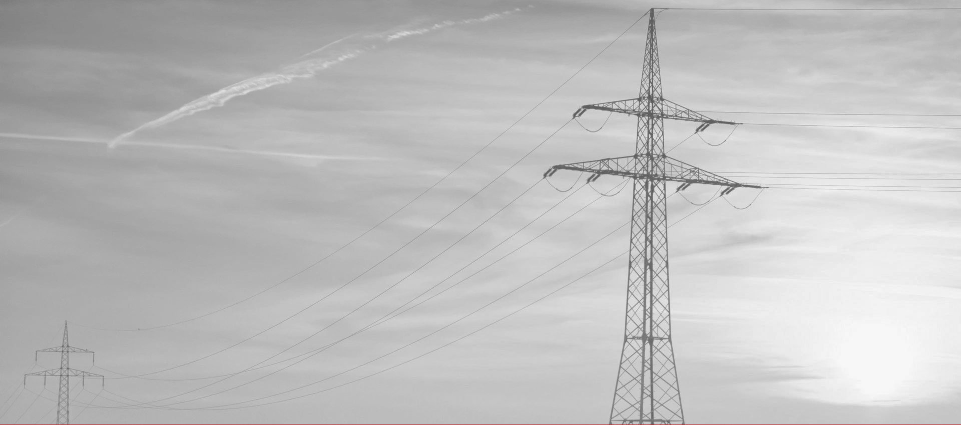 A power line tower with wires on top of it.